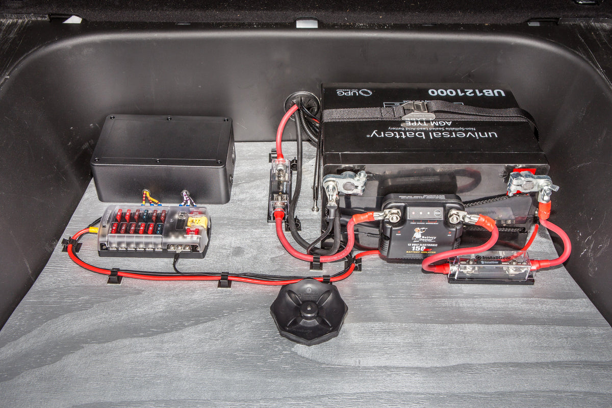 A dual battery setup wired into a vehicle engine bay, the vehicle power system this switch controller article covers.