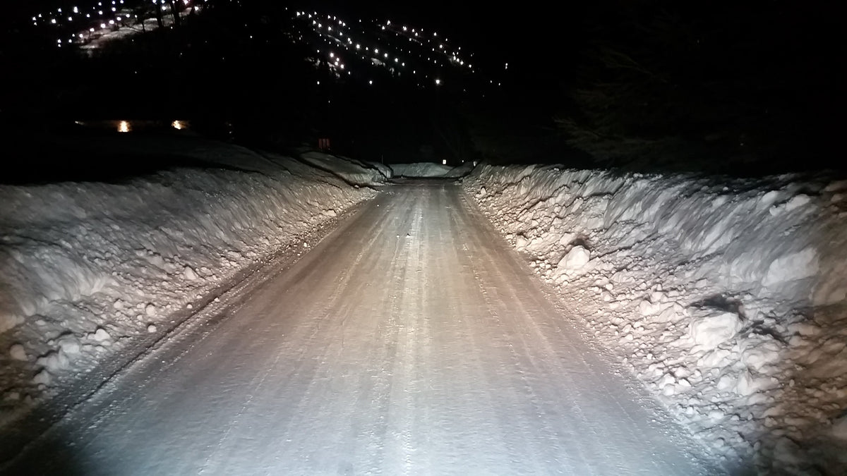 A 10-inch Black Oak LED light bar compared side by side with a Polaris halogen headlight, showing the upgrade this guide describes.
