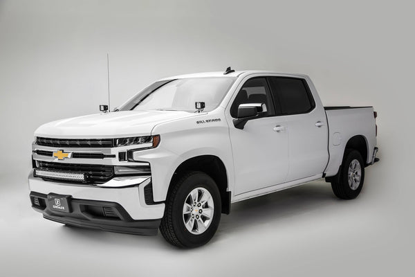 Ditch light brackets mounted on the A-pillars of a Chevy Silverado, auxiliary lighting brackets on a pickup, relevant to choosing rear and auxiliary lights.