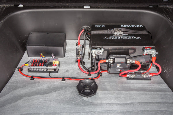 A dual battery setup wired into a vehicle engine bay, the vehicle power system this switch controller article covers.