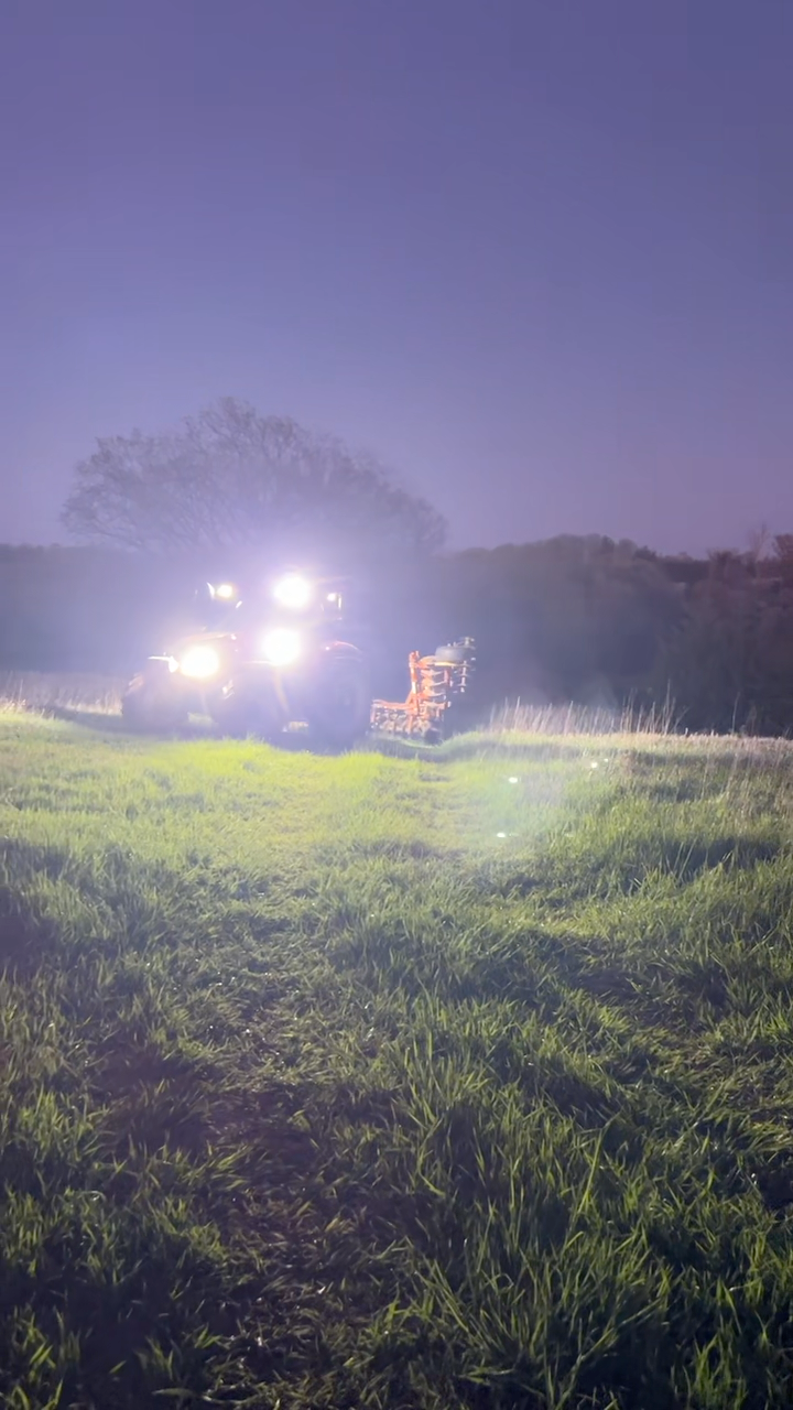 A tractor fitted with LED work lighting, the agricultural lighting setup this guide plans out.