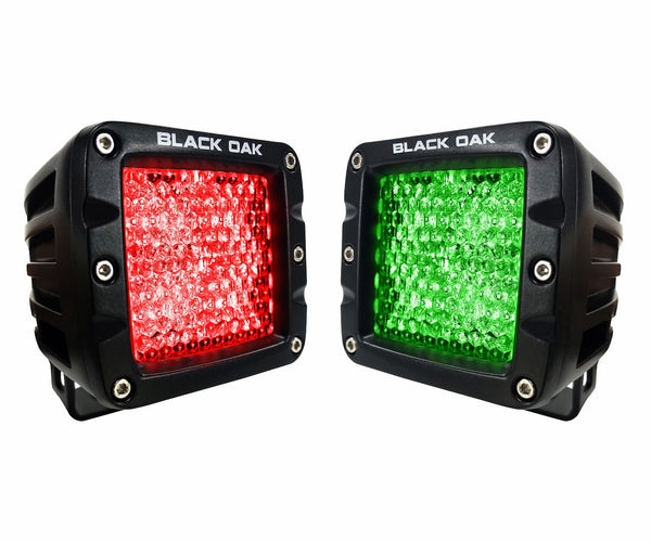 Red and green LED hunting pod lights side by side